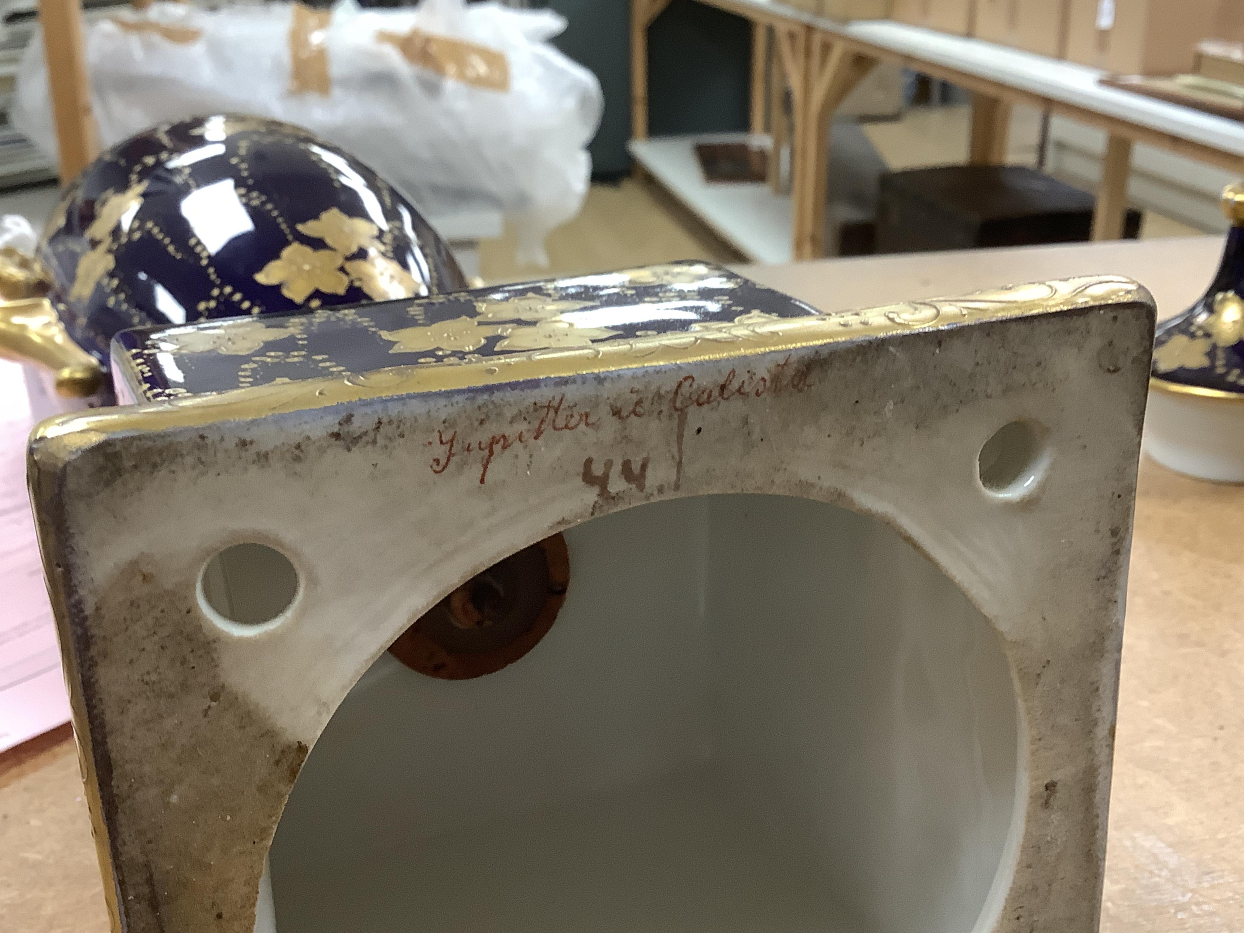 A pair of early 20th century Vienna style porcelain urns and covers, 36cm